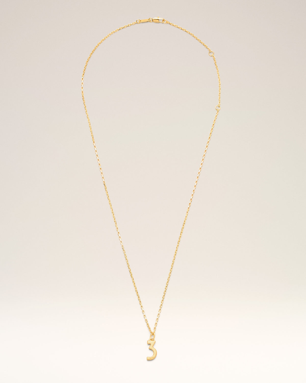 Collana con pendente “3” in ottone dorato martellato - 1